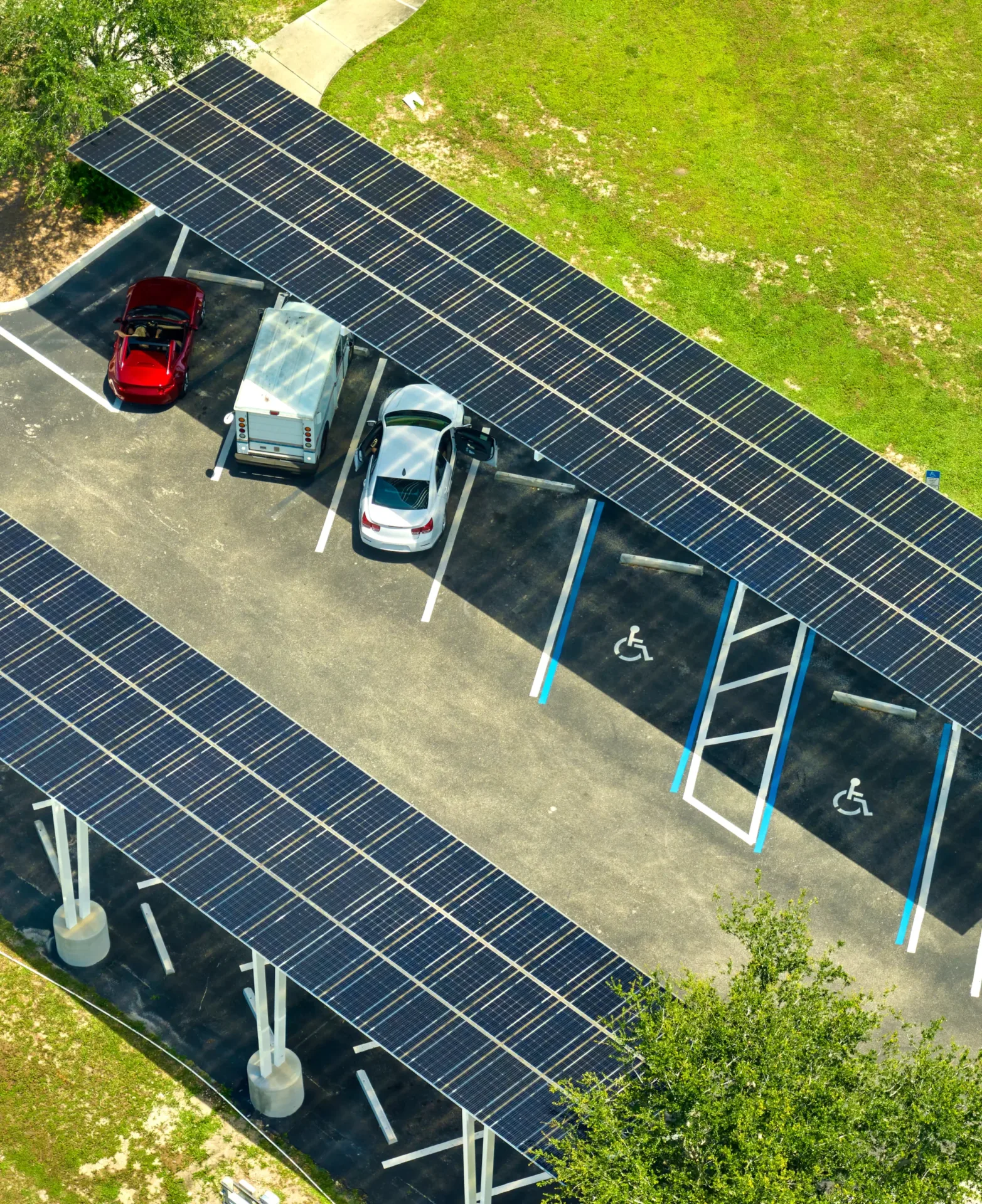Solar panels installed over parking lot for parked cars for effective generation of clean energy.