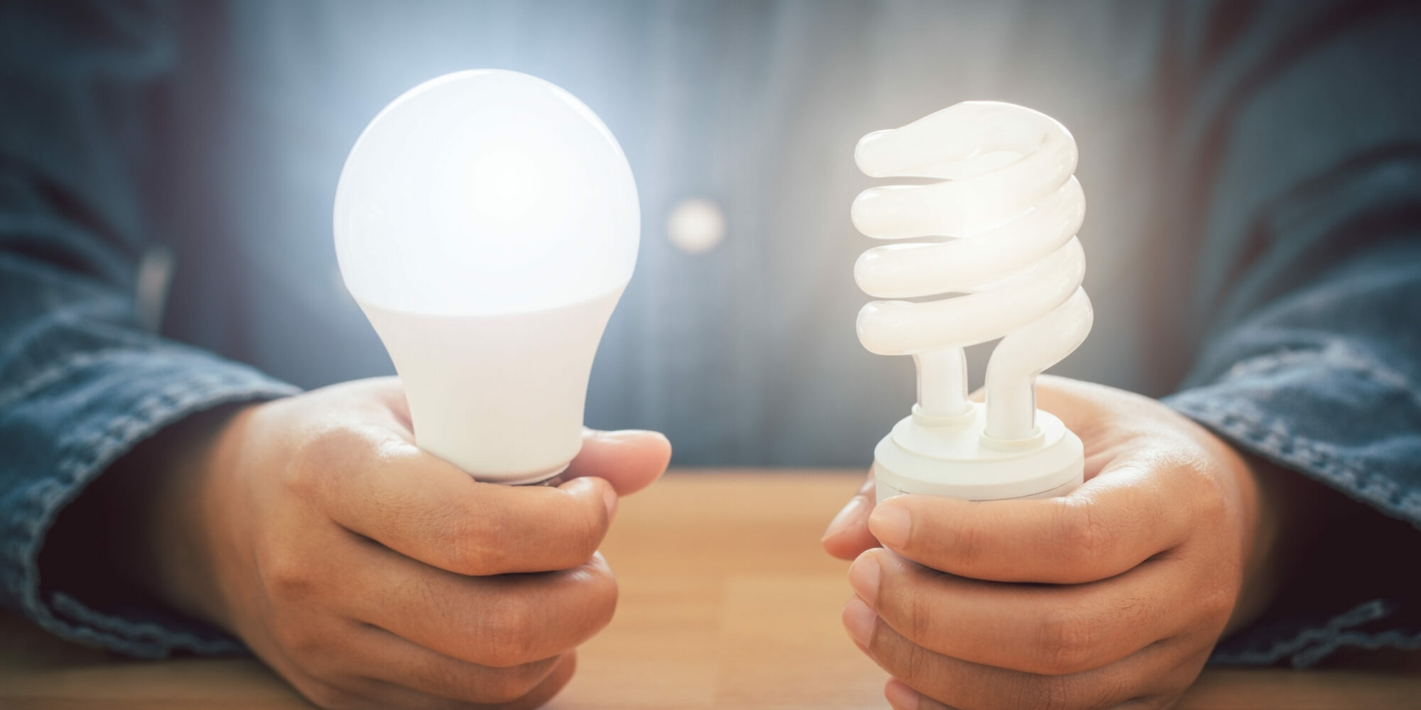 Hands holding spiral bulb and LED light bulb, Saving energy effi Hands holding spiral bulb and LED light bulb, Saving energy efficiency and and accounting finance concept.