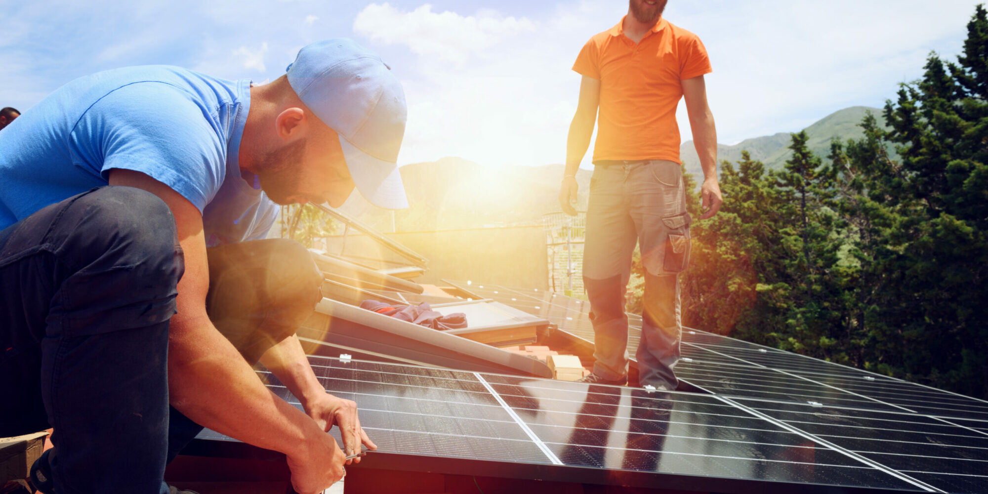 Workers assemble energy system with solar panel for electricity Workers assemble system with solar panel for electricity